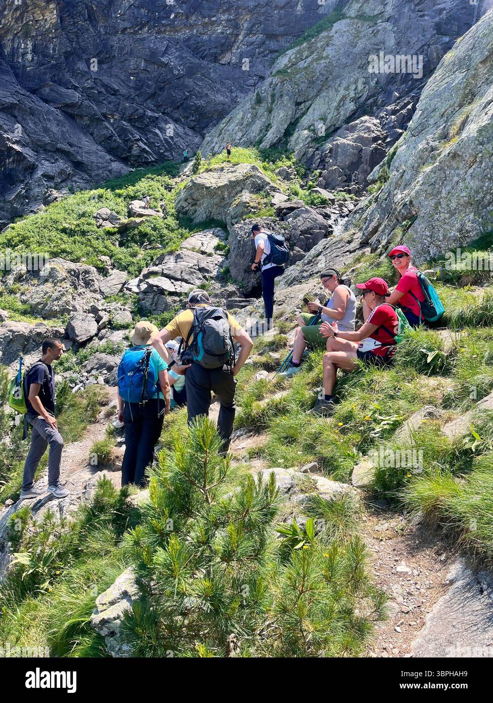 Group of hikers resting at the Skakavitsa Waterfall in Rila Nature Reserve and National Park, Rila Mountain, Bulgaria, Balkans, Southeastern Europe - Smartphone Captured Stock Image