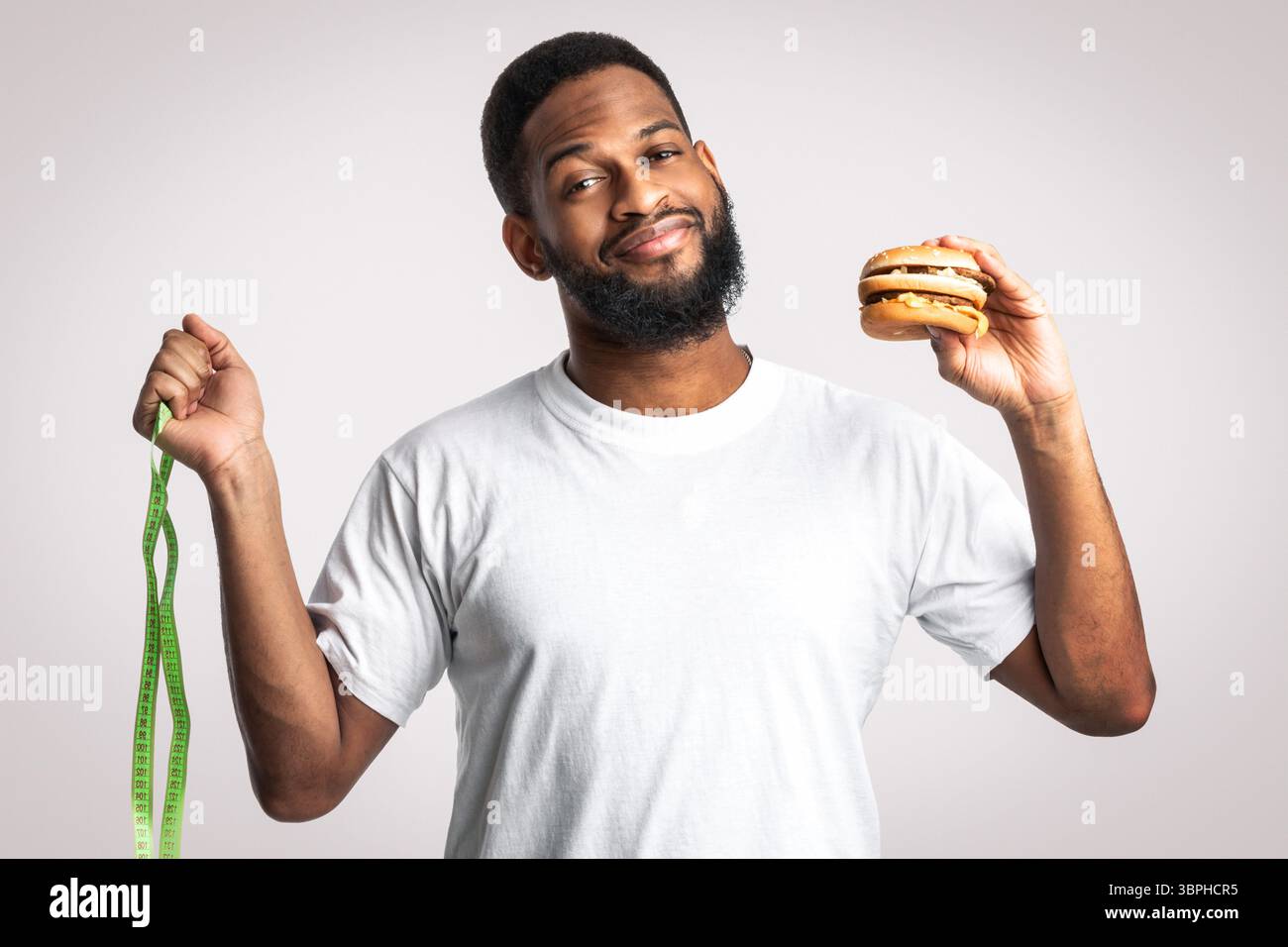 African Man Choosing Between Burger And Skipping Rope, White Background ...