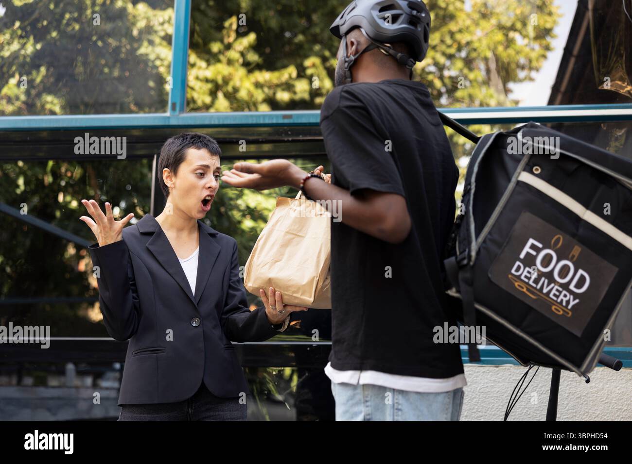 African american delivery man handing over wrong food package, dealing ...