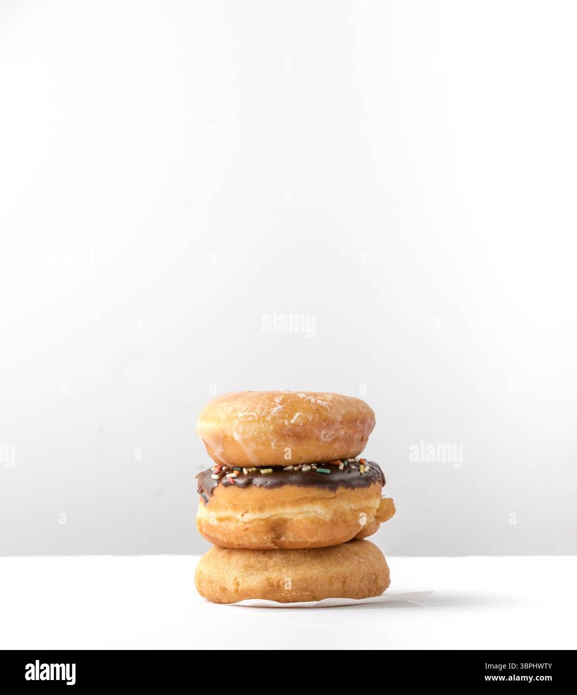 tower of assorted donuts isolated on white background Stock Photo