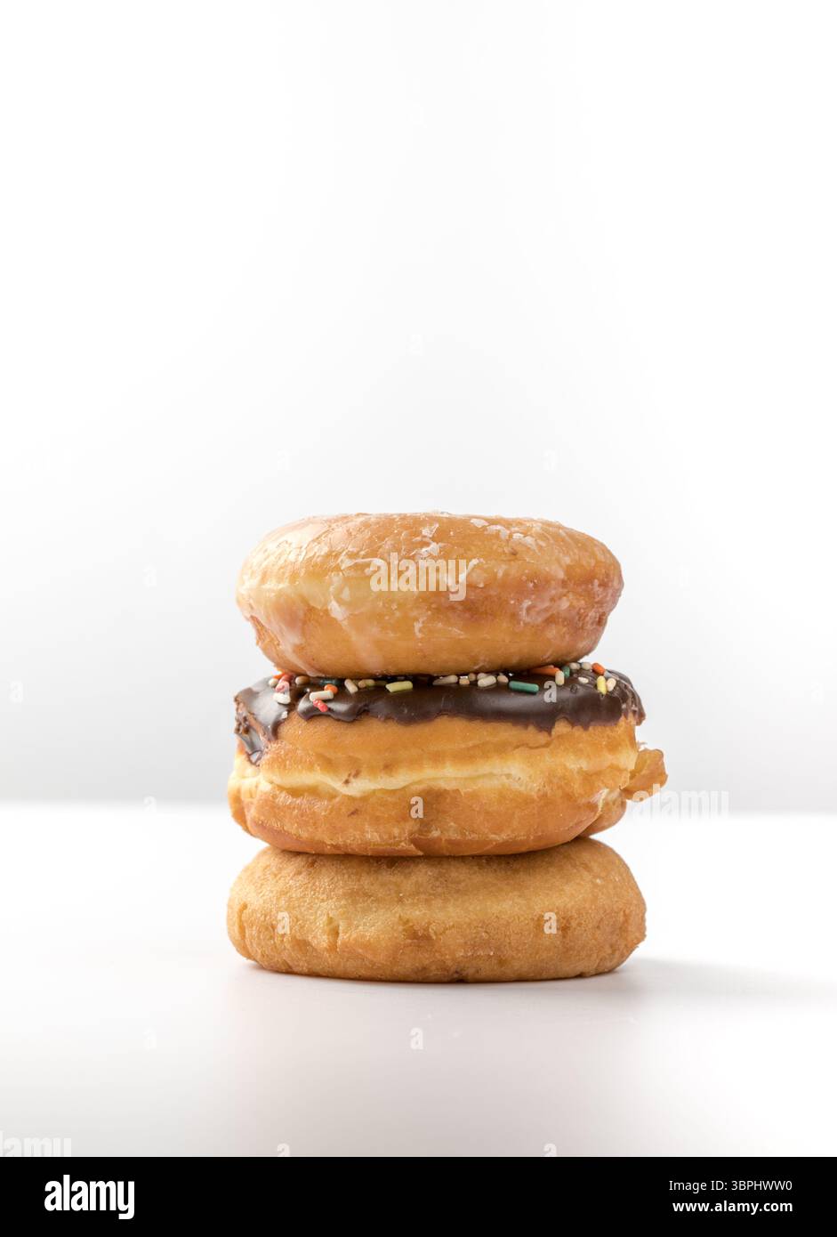 tower of assorted donuts isolated on white background Stock Photo