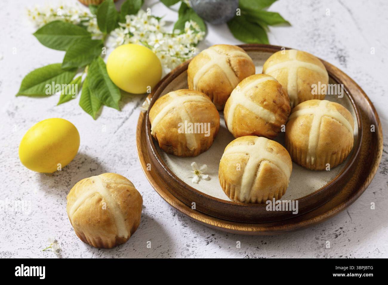 Easter baking. Homemade Easter traditional hot cross buns on a gray stone tabletop Stock Photo