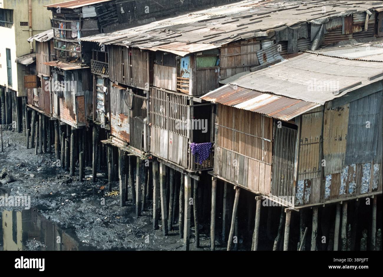 Scanned slide of a historical colour photograph of wooden shacks on ...
