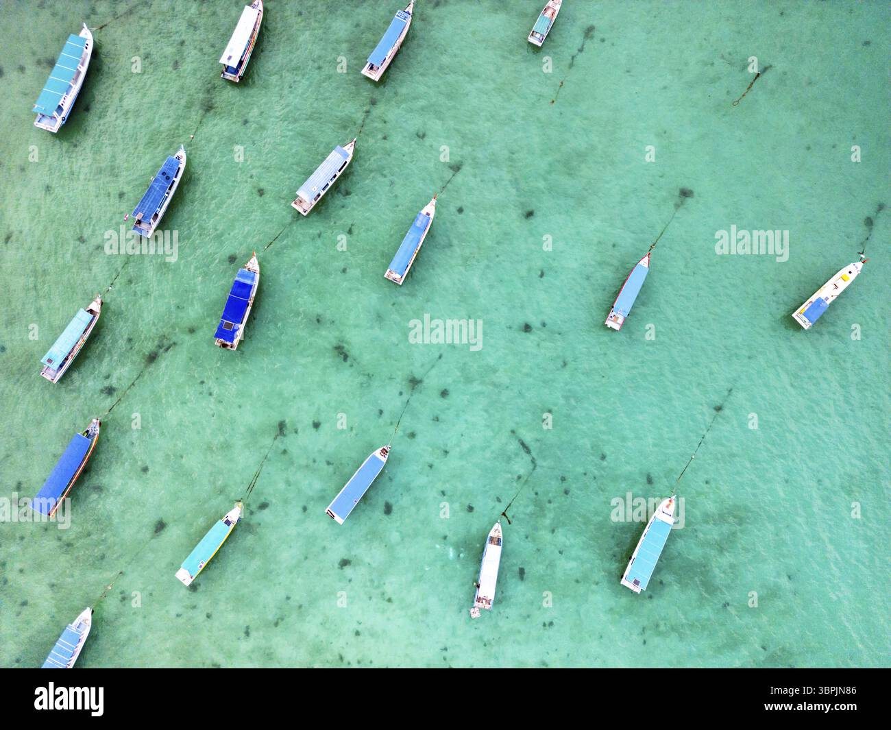 Tourist boats on tropical sea in Belitung, Indonesia, drone aerial top ...