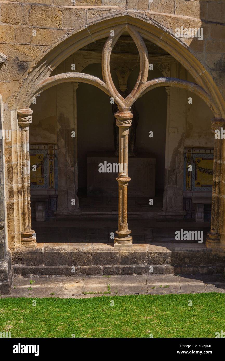 A serene cloister with intricate stone arches and columns, featuring ...