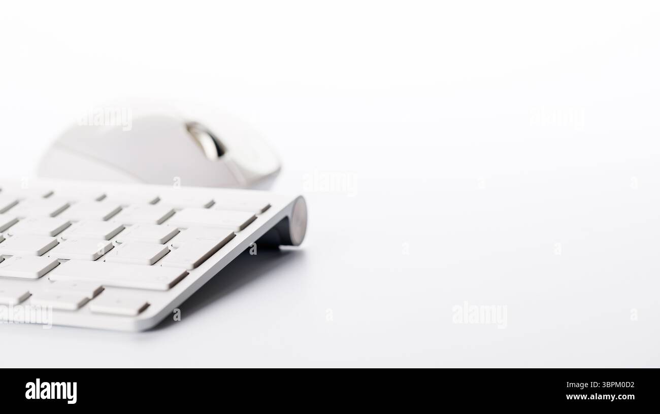 Keyboard and mouse on a white background with ample copy space for text or design elements Stock Photo