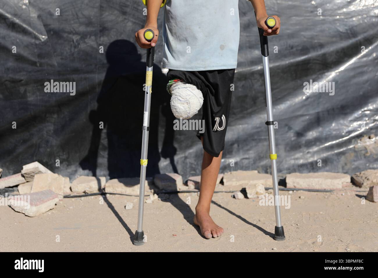 10-year-old Muhammed Omar Selim Muslih, who followed his father to get ...