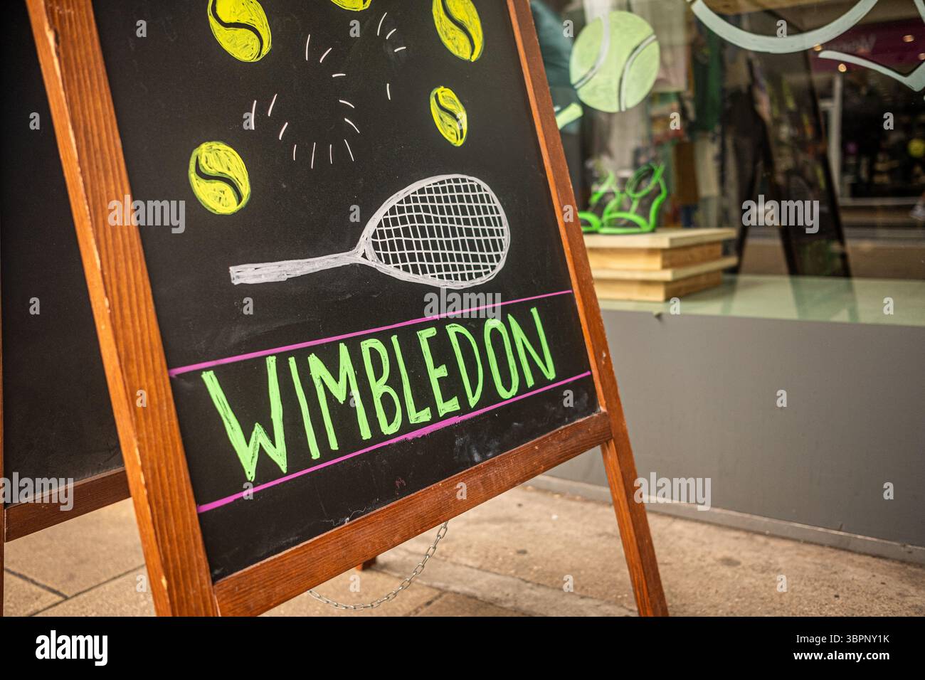 Wimbledon, London- High street shop with Wimbledon tennis illustration on blackboard Stock Photo