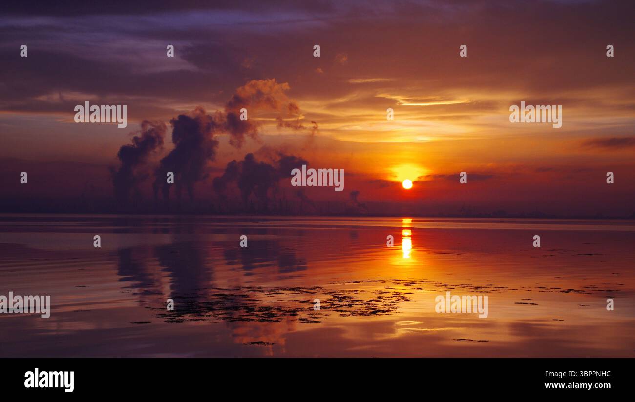 Stunning sunset over oil refinery Stock Photo