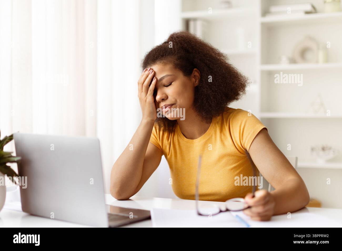 Exhausted black woman feeling tired during online work or study from home Stock Photo