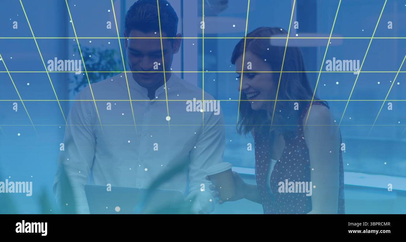 Collaborating colleagues using laptop with digital grid and data points overlay Stock Photo