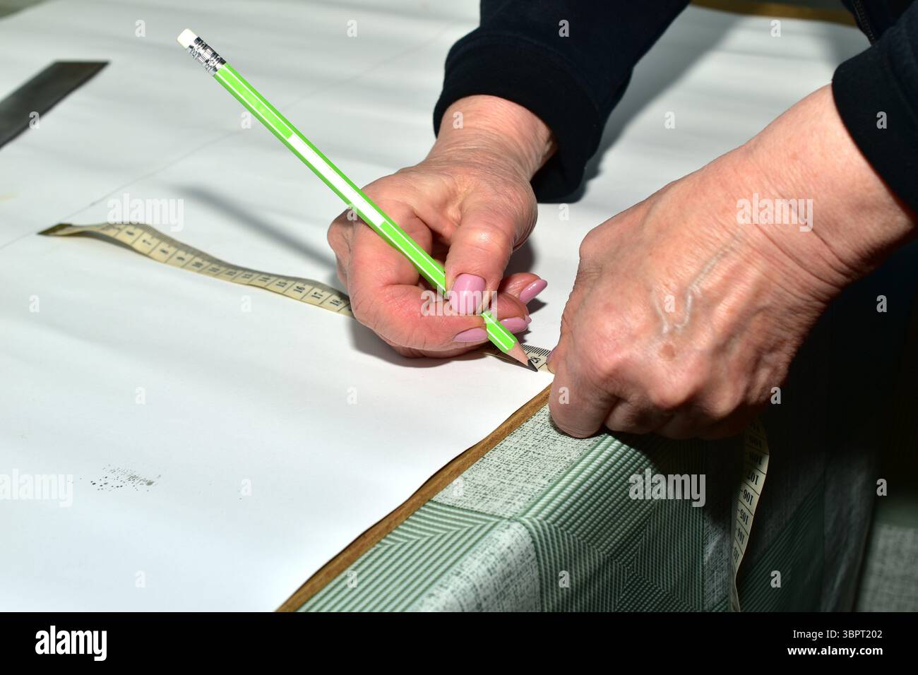 The moment when a cutter creates patterns for sewing clothes. The ...