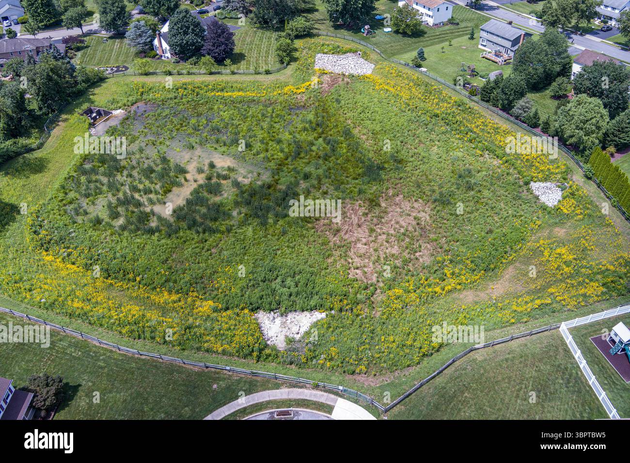 Aerial view of water retention basin swale in suburban neighborhood, Reading Pennsylvania USA Stock Photo