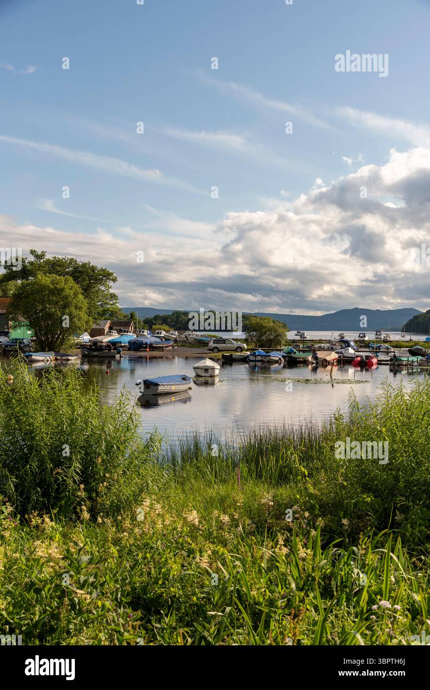 Balmaha Loch Balmaha, Lomond Scotland UK.06.07.2025.  Small boats on the edge of Loch Lomond at Balmaha from here  the West Highlands Way continues on Stock Photo