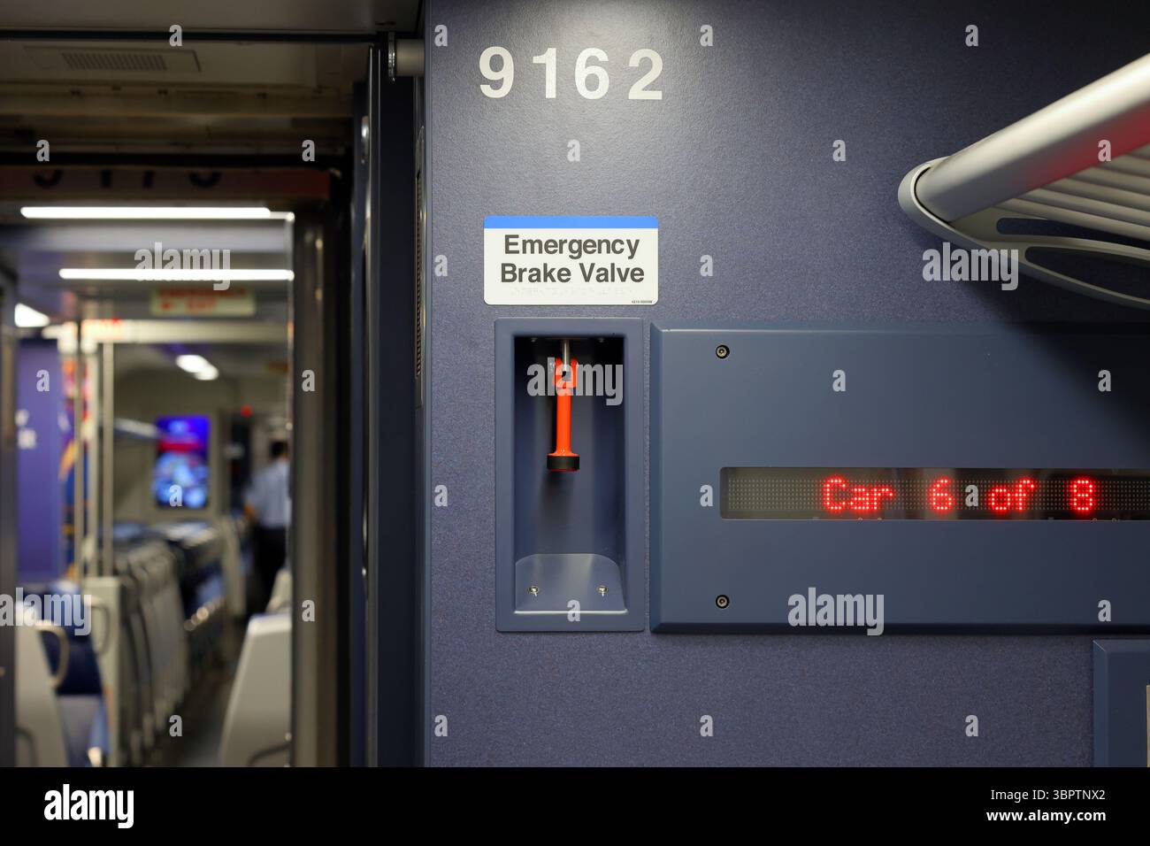 Emergency Brake Valve and signage in an American passenger railroad train car. Stock Photo