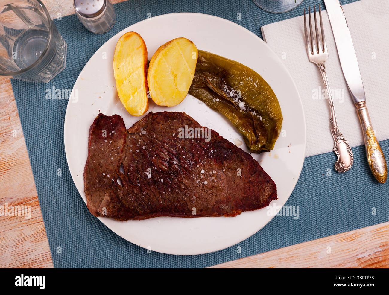 Beef sirloin steak with baked green pepper and potatoes Stock Photo - Alamy