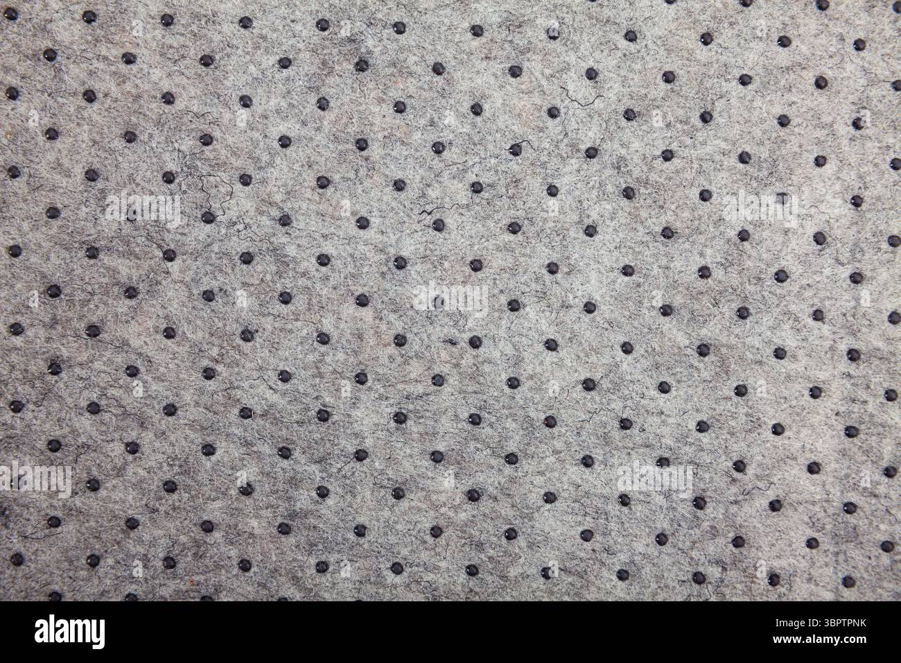 Grey felt material background with dark dots Stock Photo