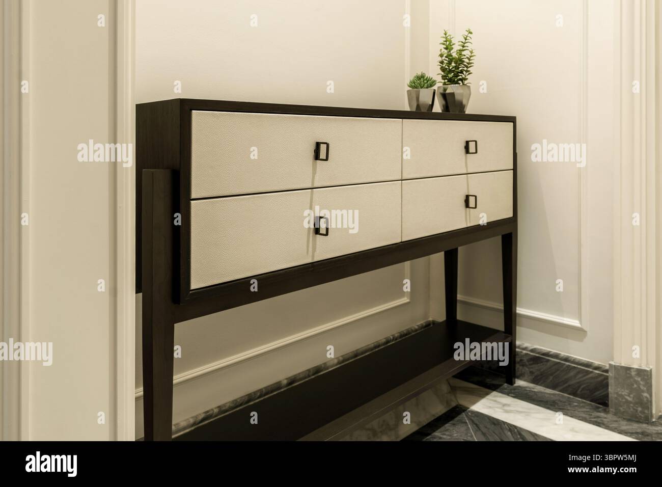 Stylish hallway with a modern dark wood and shagreen console table ...