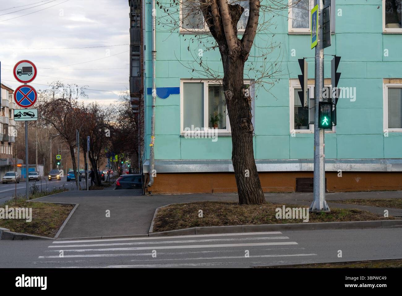 Pedestrian crossing signs on a traffic light stand at an intersection ...