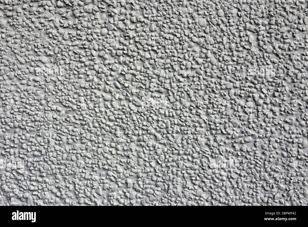 Rough stone stucco wall close-up abstract textured background Stock Photo