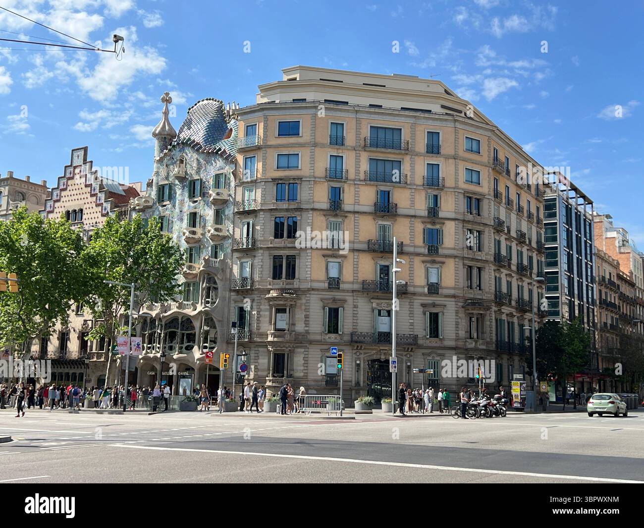 Barcelona Spain, 01 May 2022, Casa Batlló architecture on a sunny day with people and cars. - Smartphone Captured Stock Image