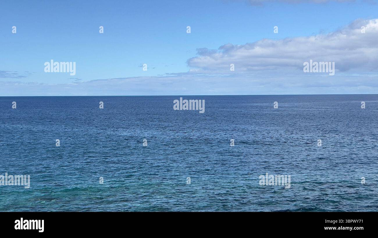 The endless atlantic ocean meets the clear blue sky in a beautiful landscape, Madeira ,Portugal - Smartphone Captured Stock Image