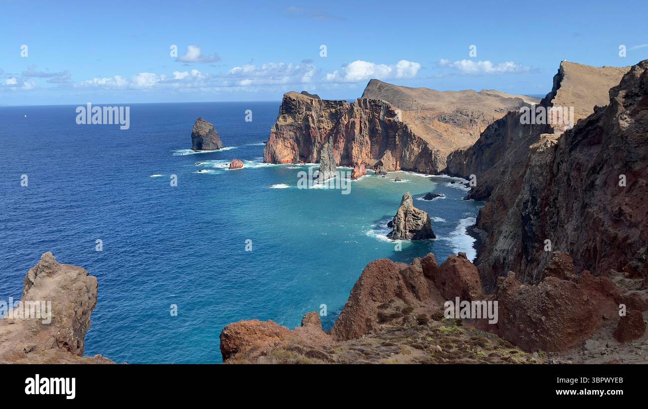 Stunning view of the dramatic cliffs meeting the vibrant blue ocean on a bright day., Madeira, Portugal - Smartphone Captured Stock Image