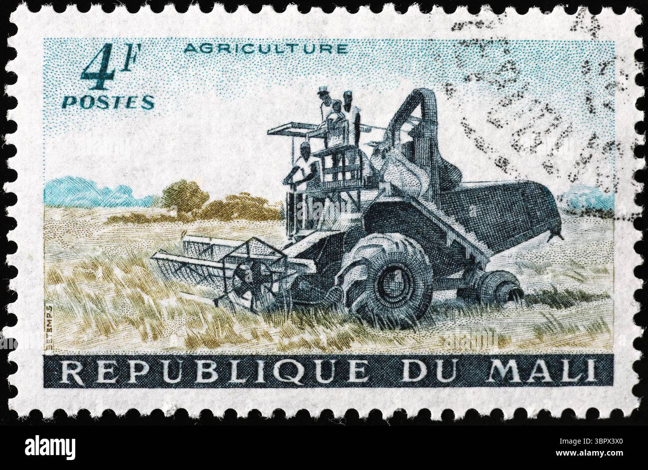 Harvesting machine in a field on malian postage stamp Stock Photo