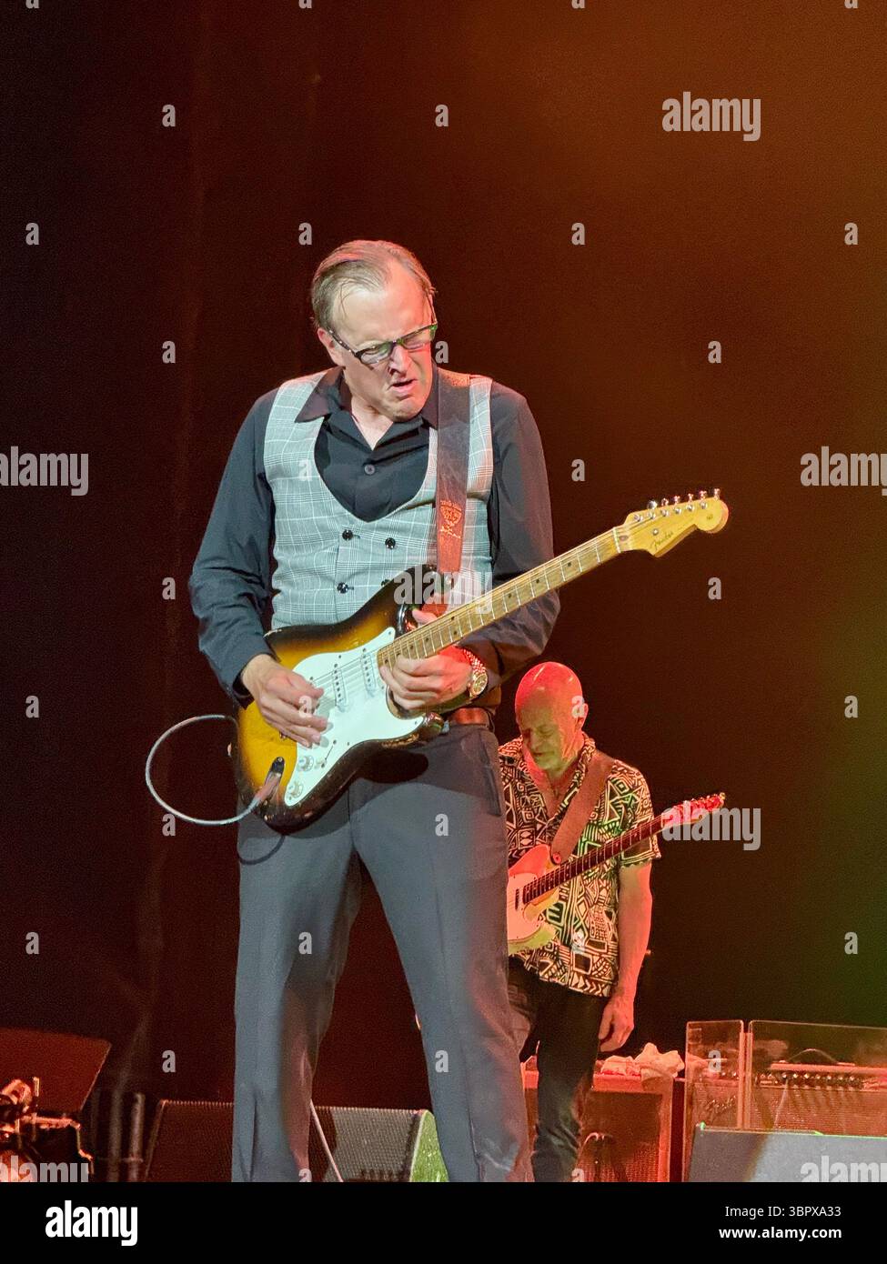 Blues guitarist Joe Bonamassa playing a Fender Stratocaster in concert performing Rory Gallagher songs in Cork for the 30th anniversary of his death - Smartphone Captured Stock Image