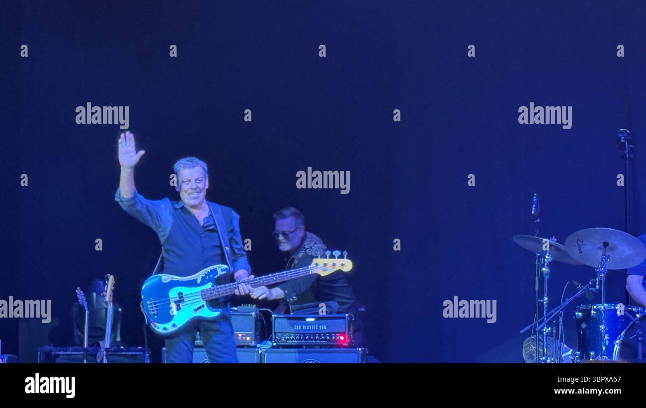 Bassist Gerry McAvoy playing a Fender bass guitar in concert performing Rory Gallagher songs in Cork for the 30th anniversary of his death - Smartphone Captured Stock Image