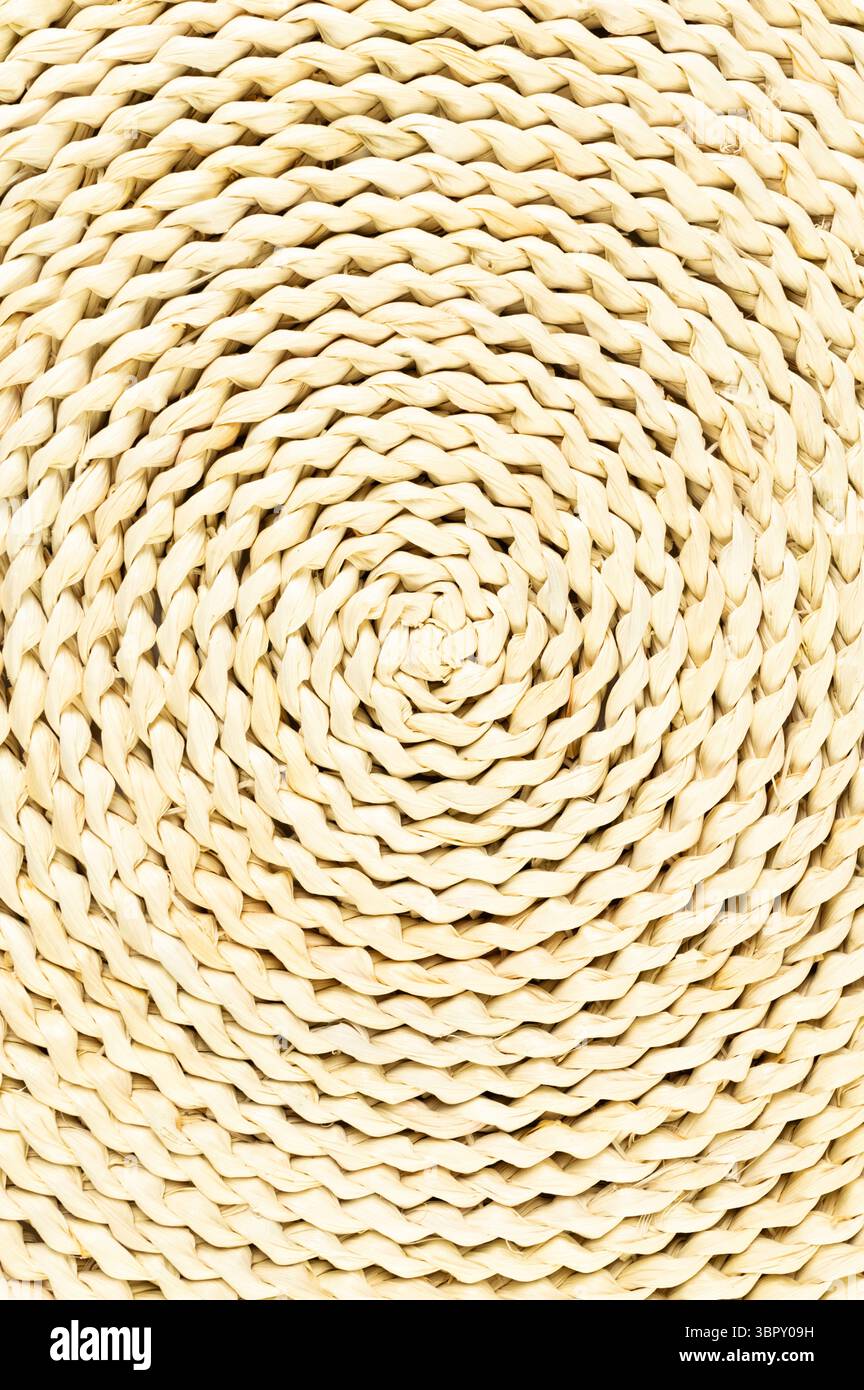 Top view of brown wicker table mat on white background. Straw round tray, flat lay, copy space. Stock Photo