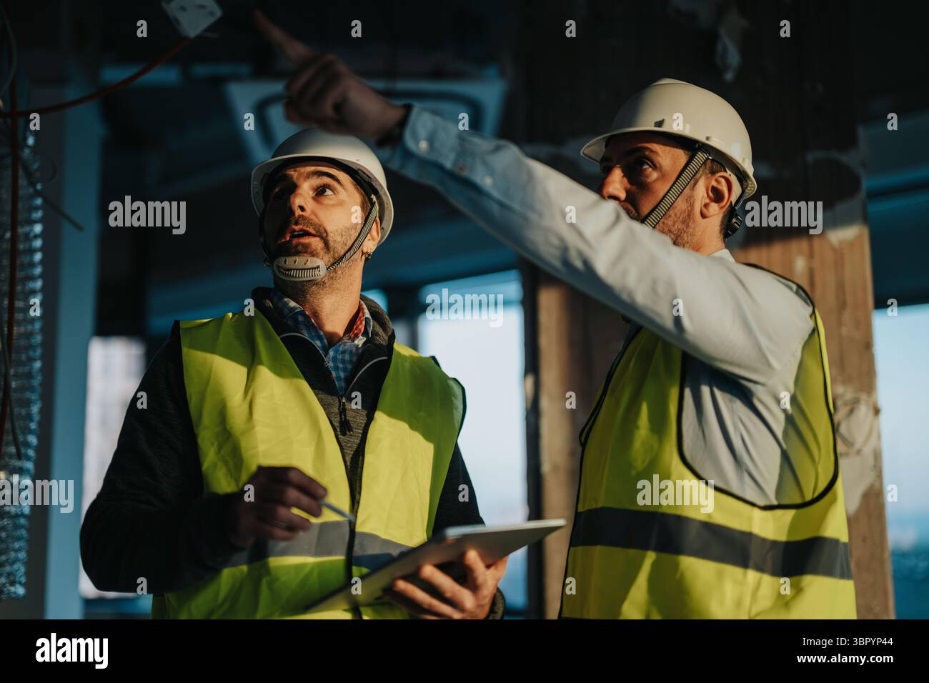 Construction workers inspecting a site with focus on planning and collaboration Stock Photo