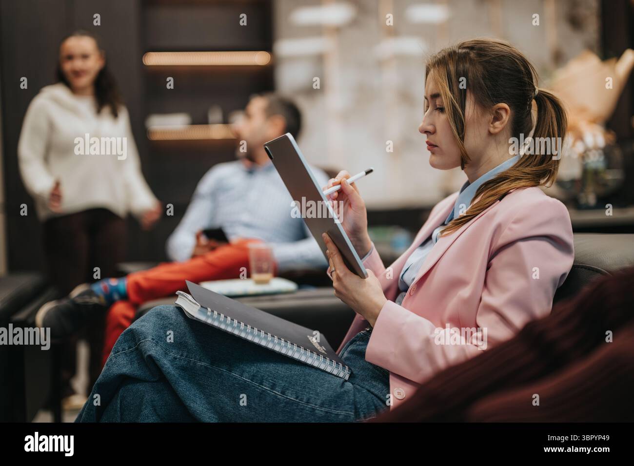 Prefessional Taking Notes Focused professional woman taking notes during a collaborative team ...