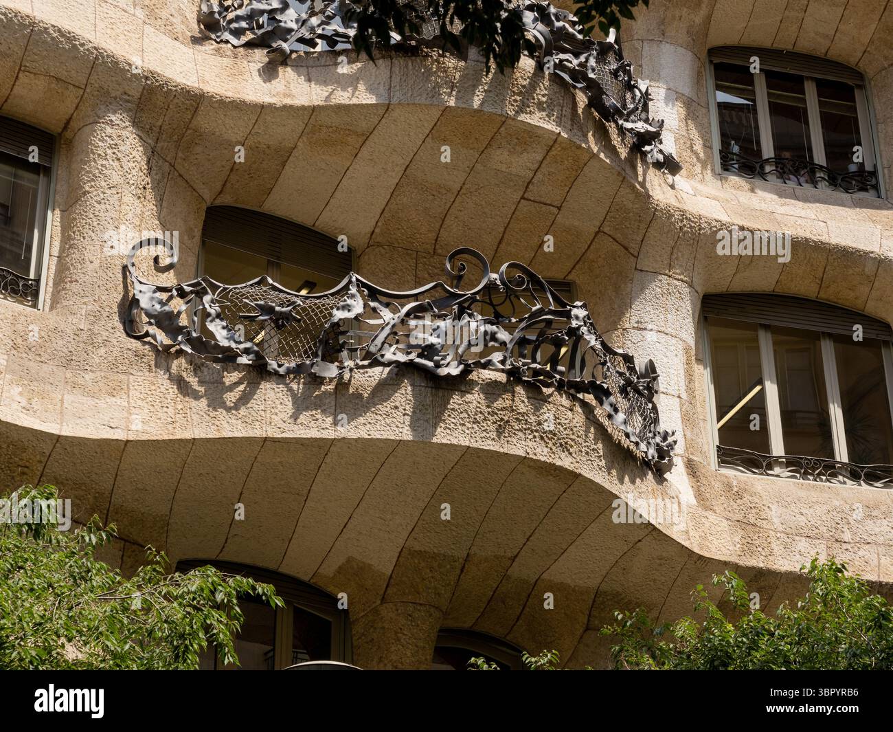 The unique, organic forms of the stone facade and wrought-iron ...