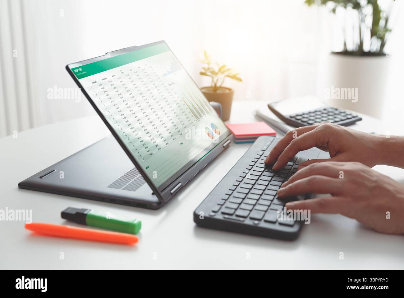 Man using 2 in 1 laptop to financial data analysis. Analyst at work. Stock Photo