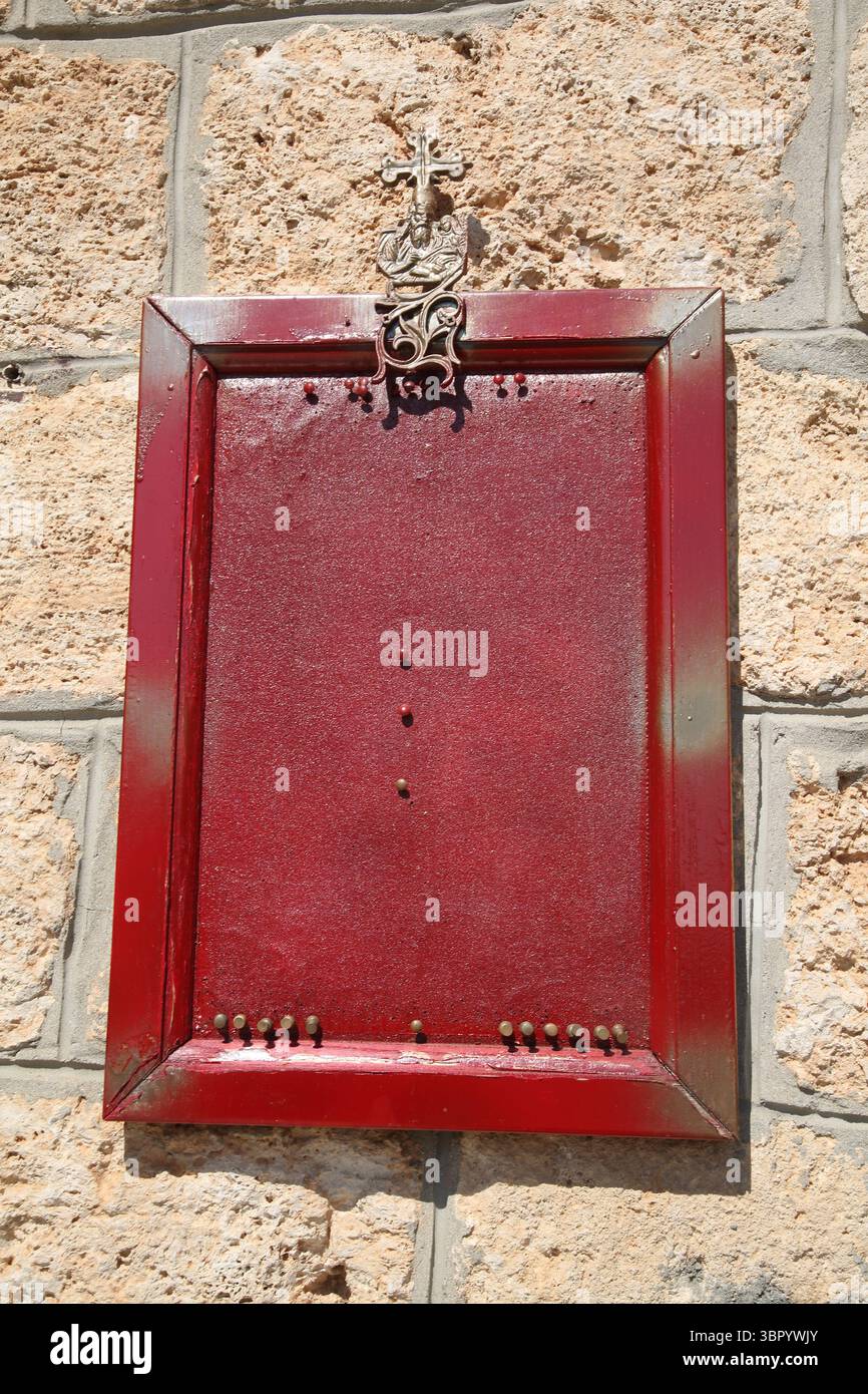 Empty Red Noticeboard and pins outside  at Agios Nikolas Church Vari-Voula- Vouliagmeni Attica Greece Stock Photo