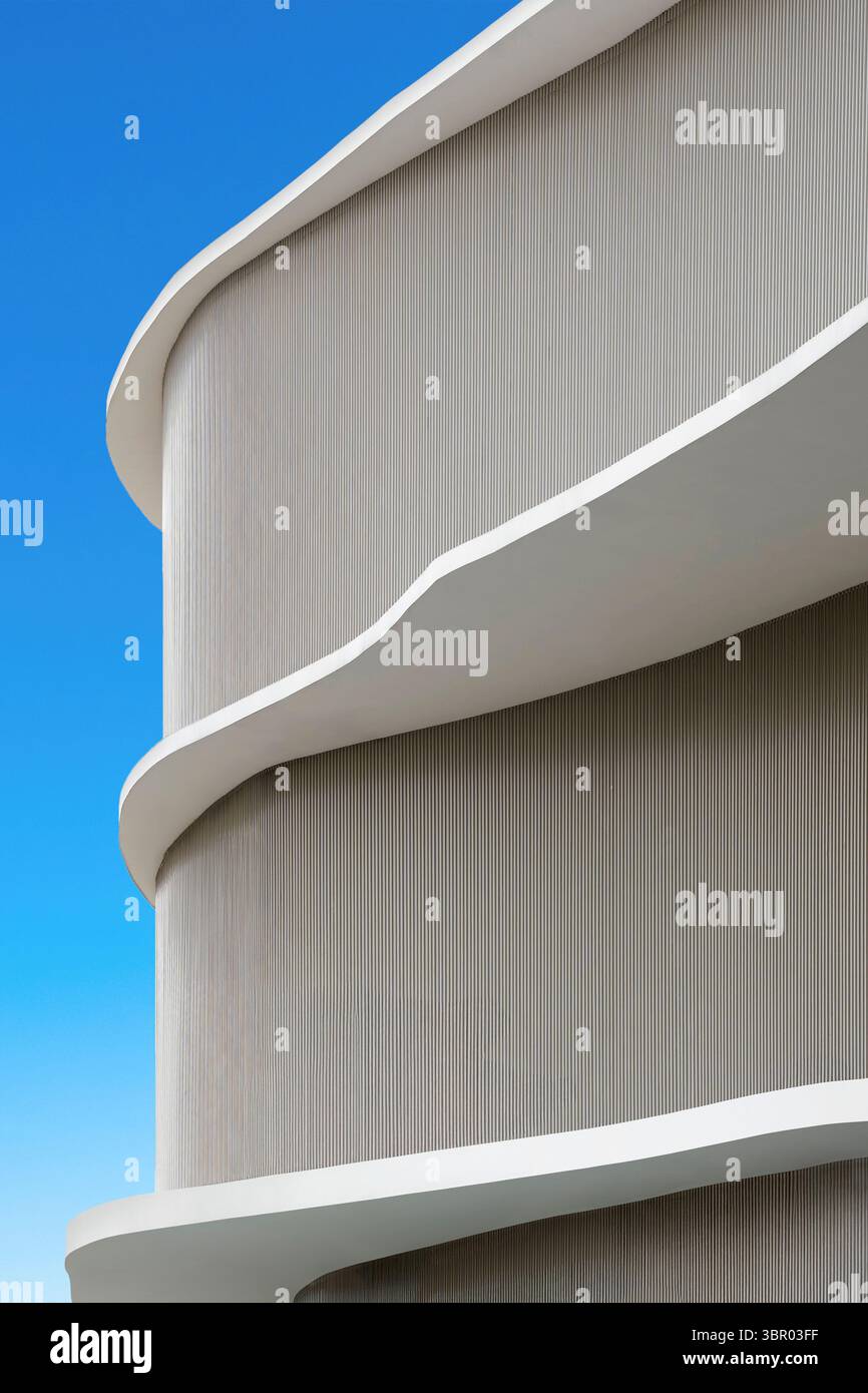 Abstract detail of a modern building with curved white balconies and a ...