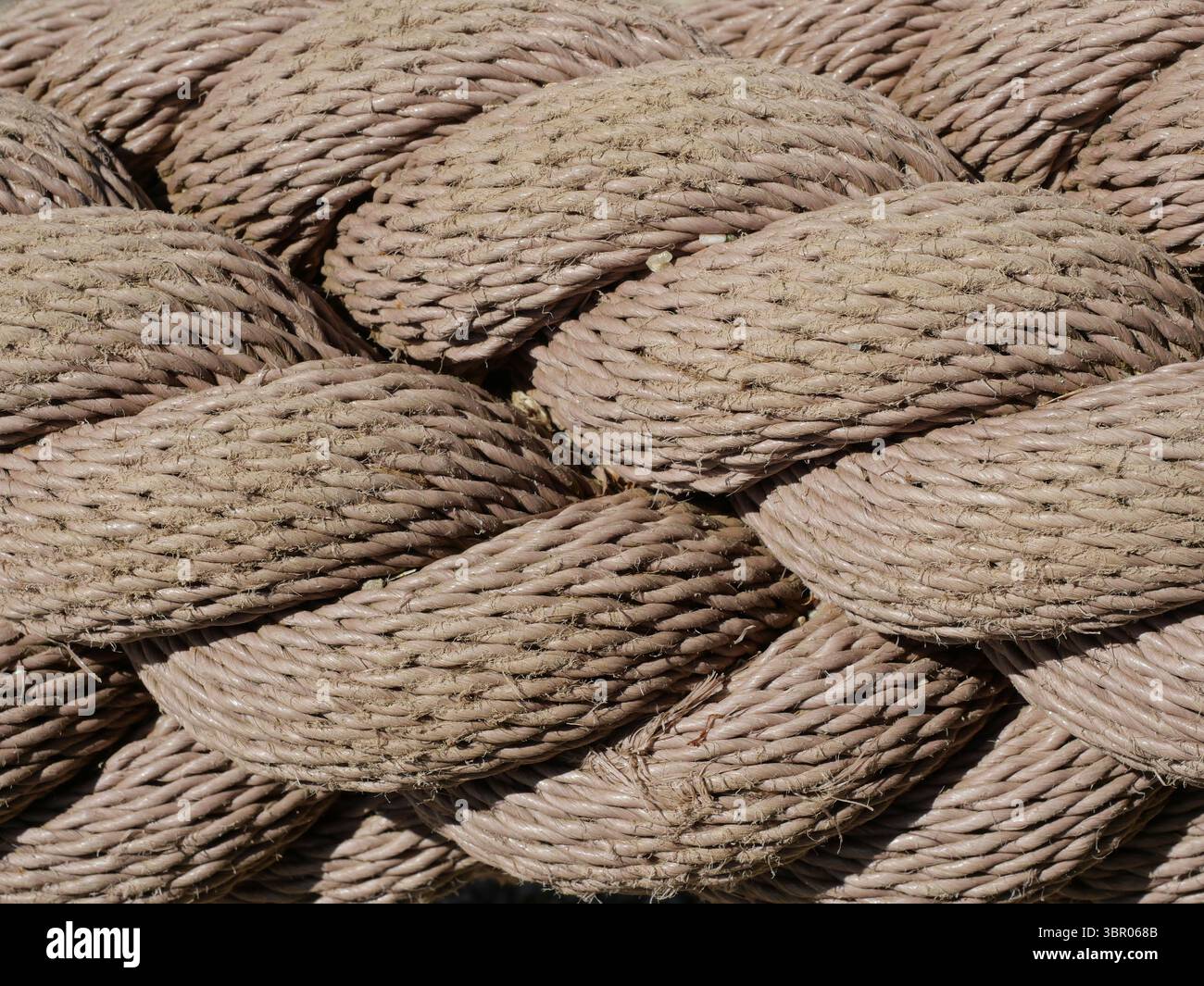 Thick twisted rope as maritime design feature in park. Ideal for design ...