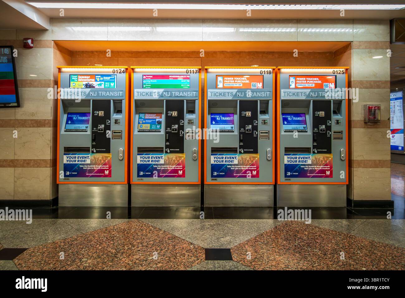 New York, NY - US - Jul 6 2025 A row of NJ Transit ticket machines lines the polished floor of Penn Station, offering riders fast, digital access to r Stock Photo
