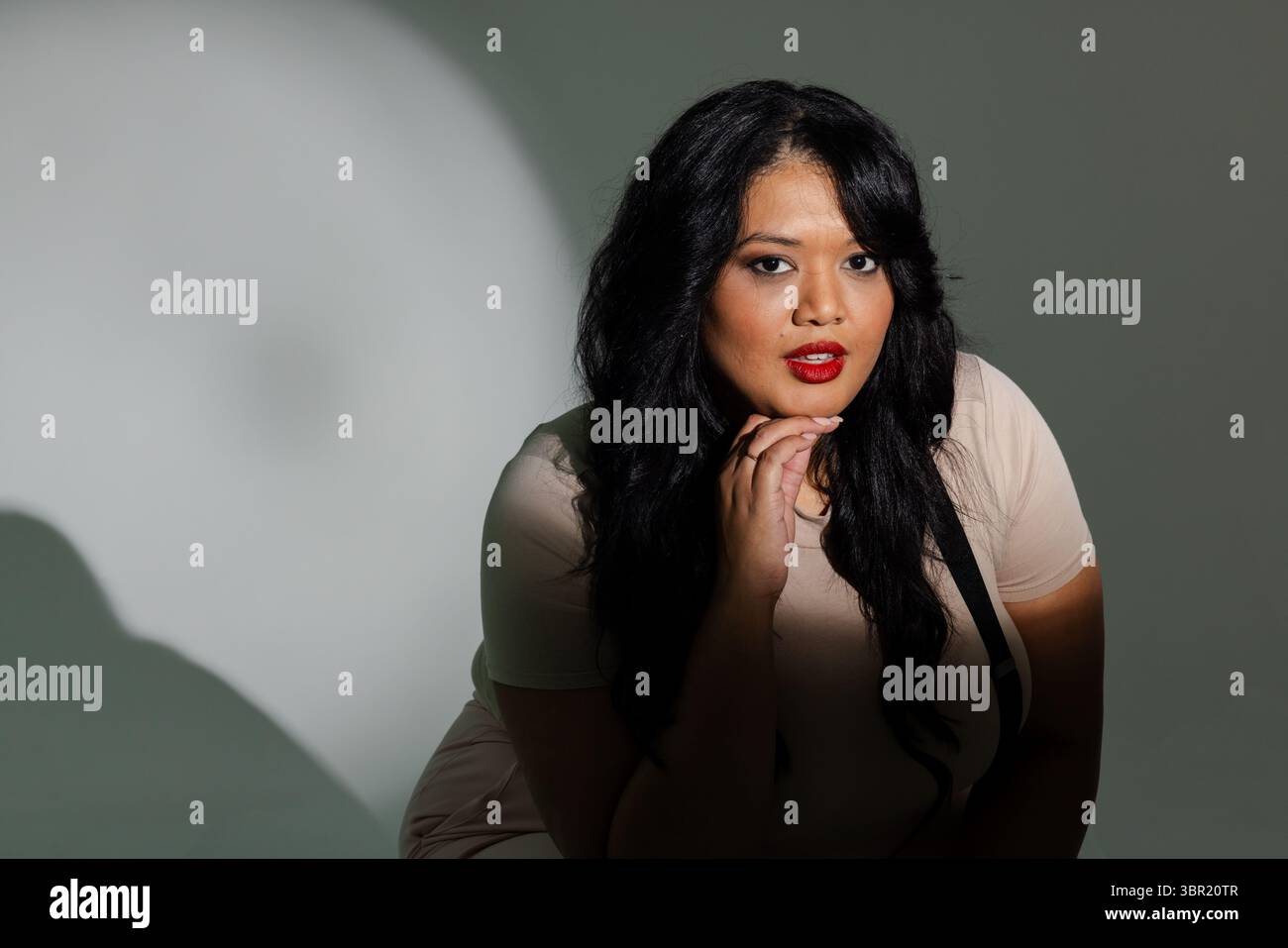 Female wearing beige top hi-res stock photography and images - Alamy