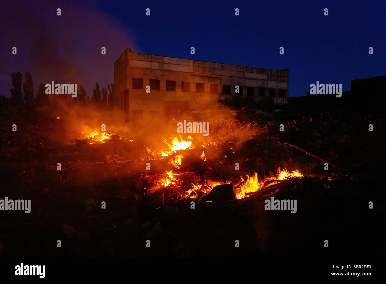 Burning building ruins at night, consequences of attack concept Stock ...