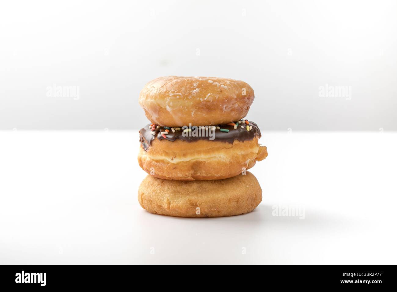 tower of assorted donuts isolated on white background Stock Photo