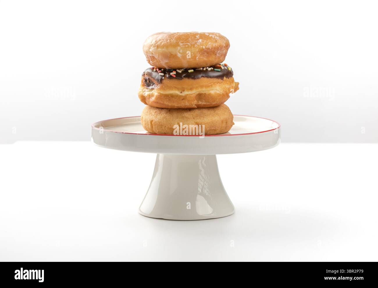 tower of assorted donuts isolated on white background Stock Photo