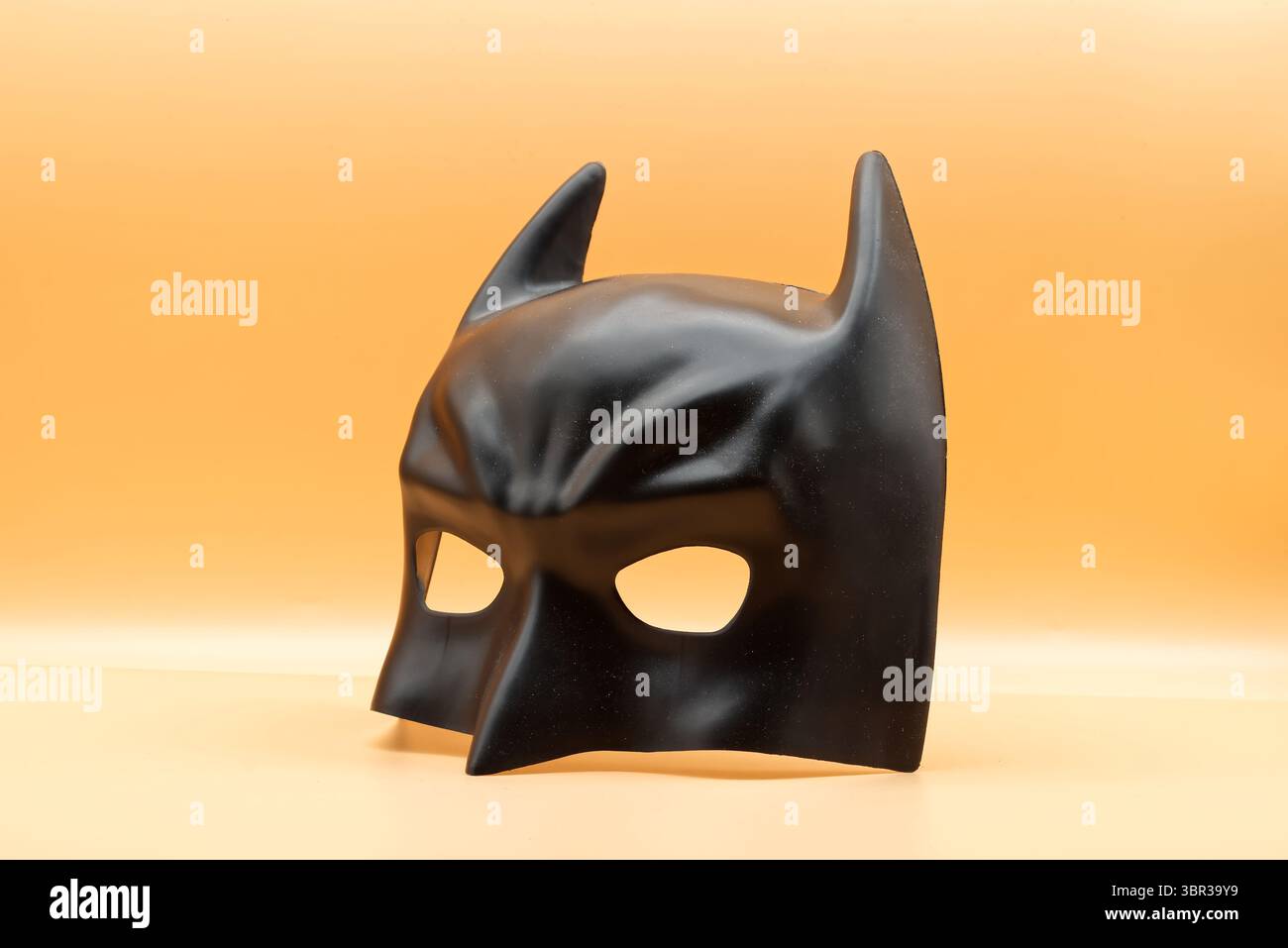 The Batman mask by Ciao Srl isolated on orange background. Stock Photo