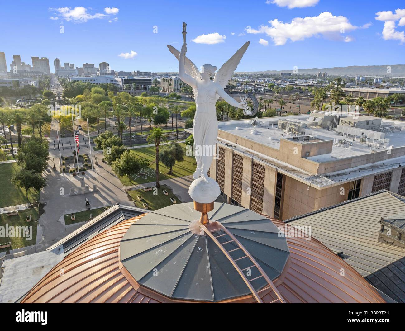 Aerial view of the copper-clad dome of the Arizona State Capitol crowned by Winged Victory gleams against the Phoenix skyline, Phoenix, Arizona, United States. Stock Photo