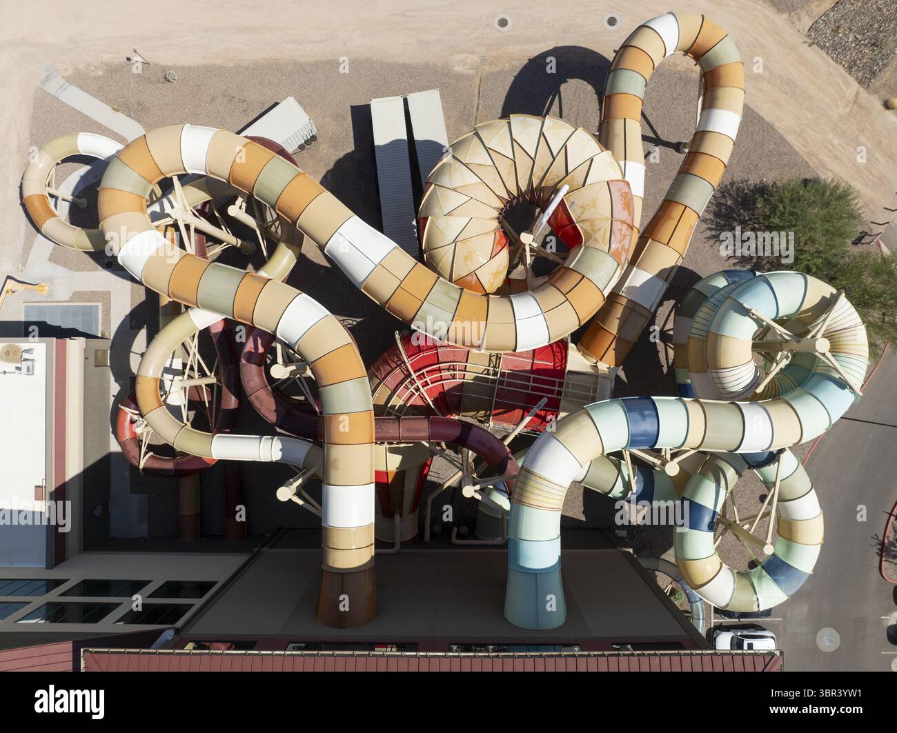 Aerial view of vibrant water slides twisting and turning in a whimsical dance of color against the stark desert backdrop, Scottsdale, Arizona, United Stock Photo