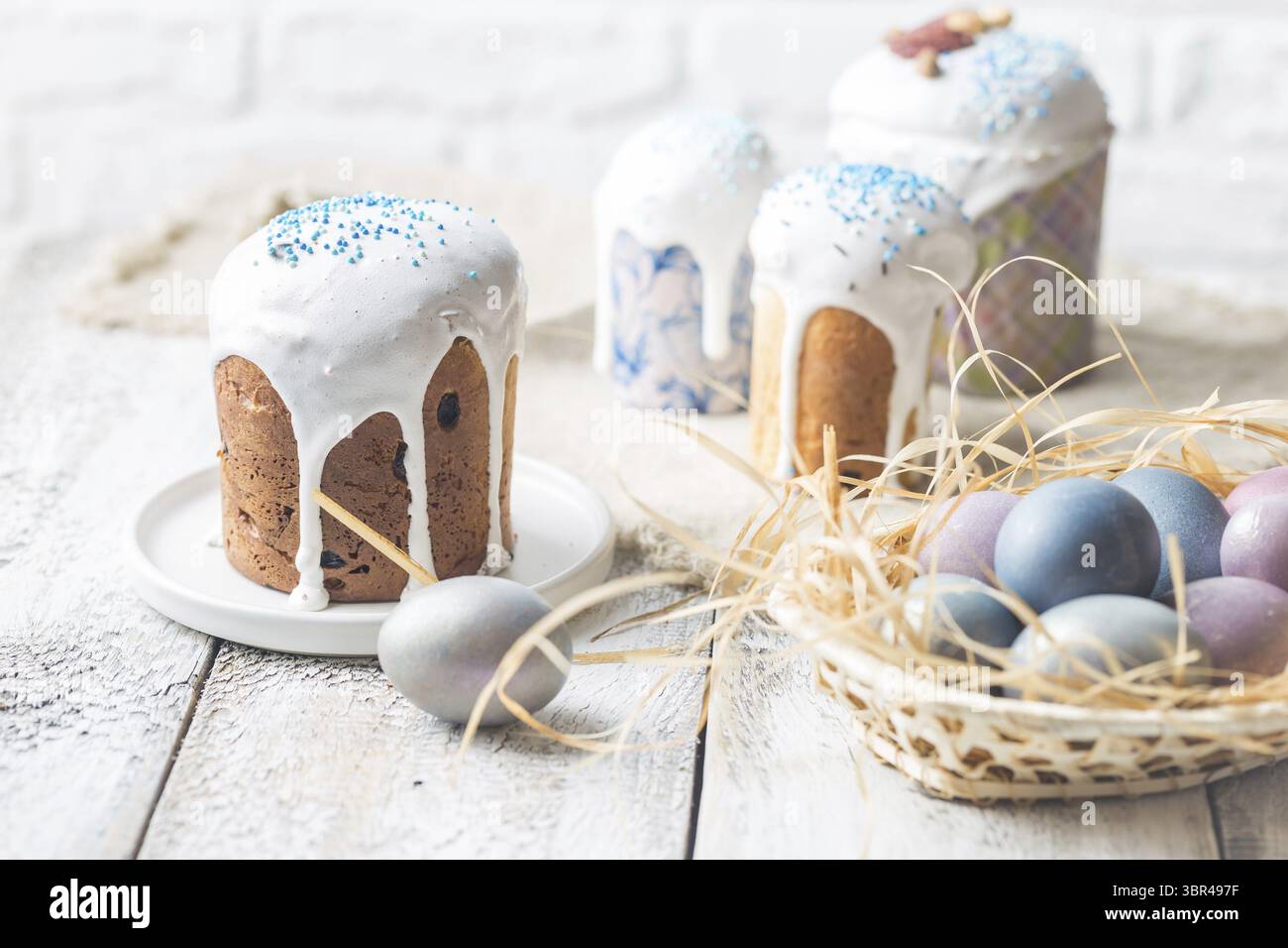 Easter table with Easter cakes and Easter eggs over white background Stock Photo