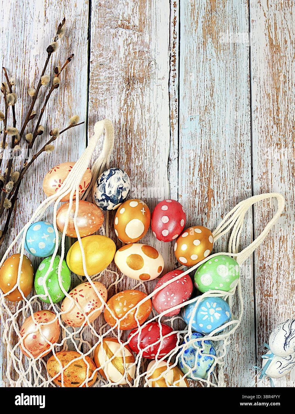 Composition with decorated Easter eggs in an eco-bag and willow ...