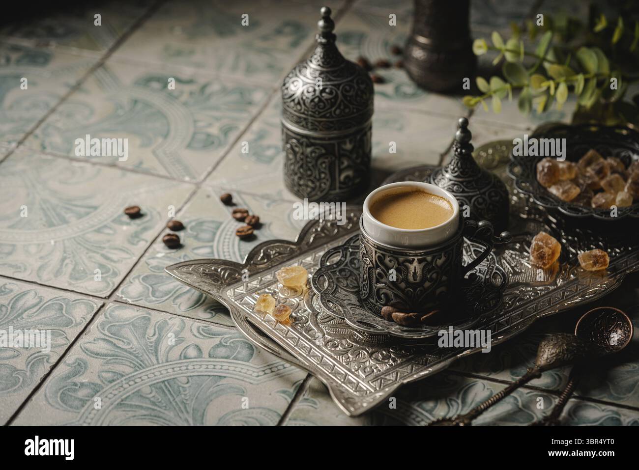 Coffee in metal Turkish traditional cup and coffee beans on tile background Stock Photo