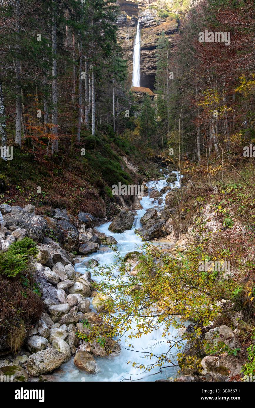 Waterfall flowing in the valley. Turquoise water flows through a rocky riverbed. Slovenia. Triglav Bistrica cascade Stock Photo